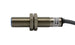 The I12000001 SENSOR DE PROX12MM DIAMSENSA 2MM 20-250 SI12A2 NC is a cylindrical M12 inductive sensor with threaded body, two hex nuts, attached cable, visible label, and IP67 protection for reliable operation.